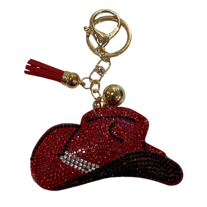 Keychain with red and black cowgirl hat  and tassel on a white background
